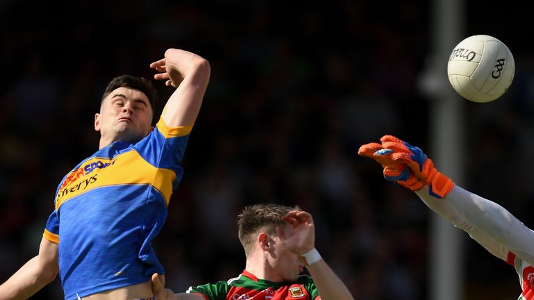 Michael Quinlivan punches to the net