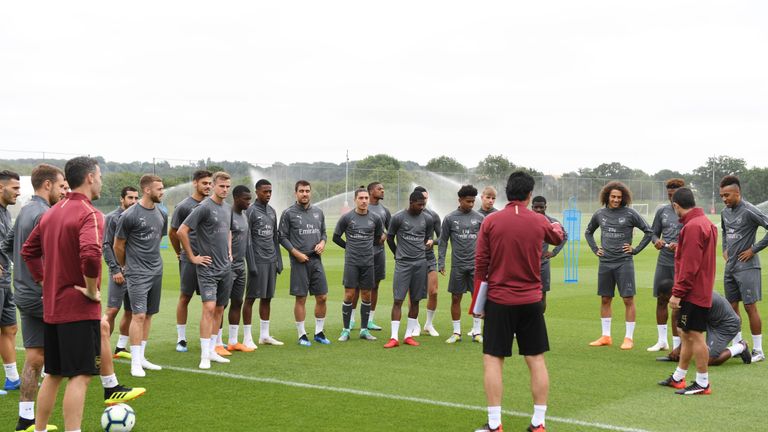 Arsenal players receive instructions from their new coaching staff
