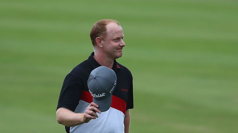Richard McEvoy walks down the 18th fairway