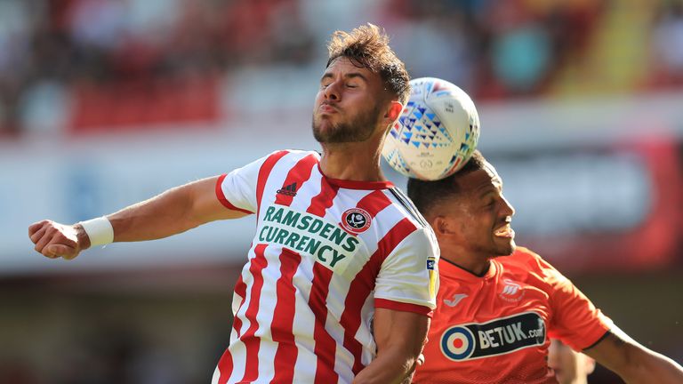 Sheffield United's George Baldock and Swansea City's Martin Olsson in action at Bramall Lane