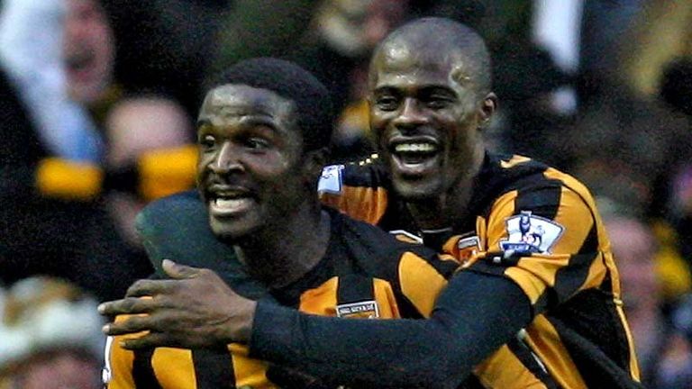 Bernard Mendy and George Boateng of Hull City celebrate Jamie Carragher's own goal.