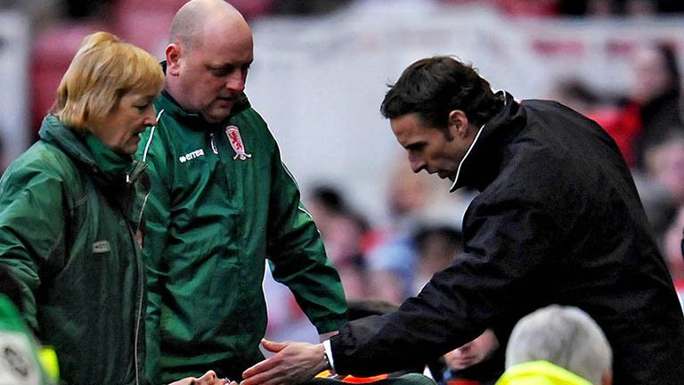 Jeremie Aliadiere is stretchered off just before half-time.