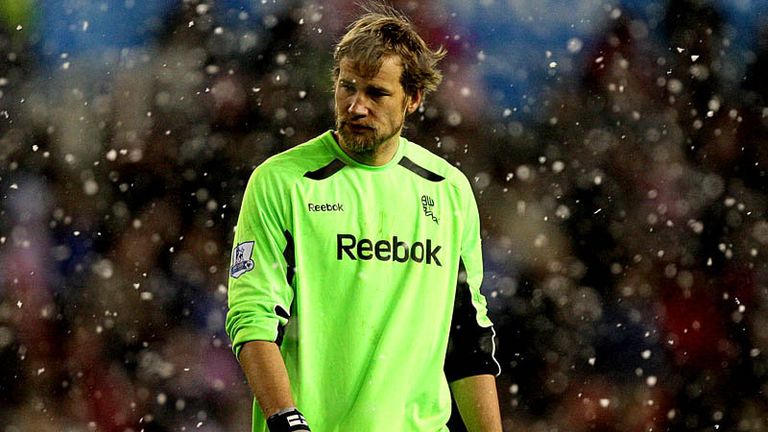 Jussi Jaaskelainen makes his way to the dressing room at a snowy Britannia Stadium.