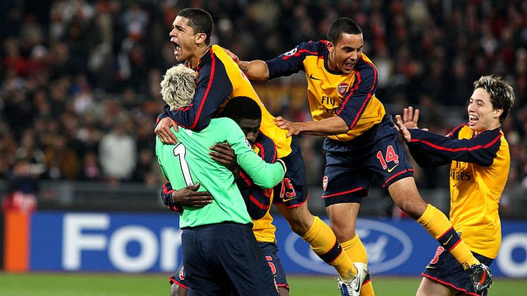 Arsenal celebrate making the quarter-finals after Tonetto misses his penalty for Roma.