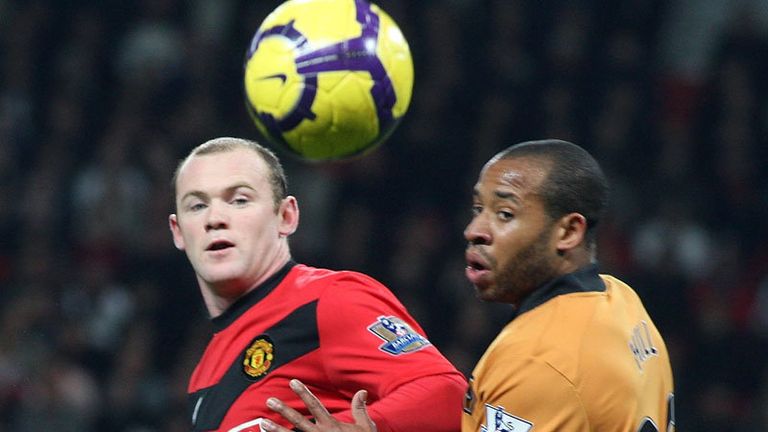 Wayne Rooney tussles with Matthew Hill in the opening stages of Man Utds game with Wolves