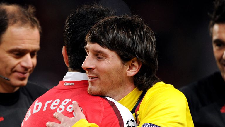 Lionel Messi and Cesc Fabregas embrace before the game begins