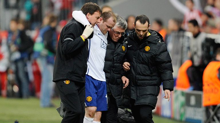 Rooney is helped from the field after suffering an ankle injury in the 90th minute