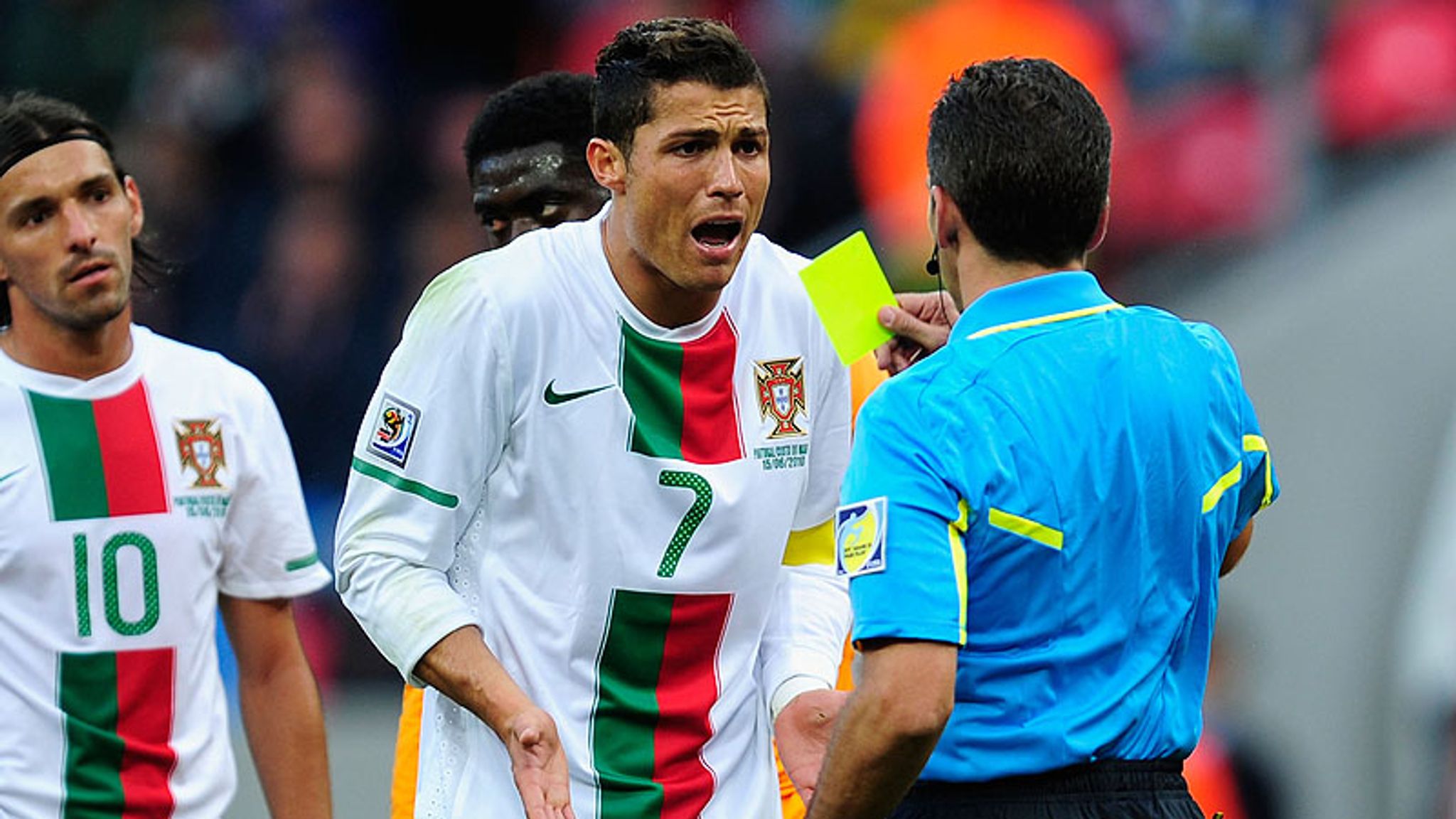 Guy Demel of Ivory Coast argues with Cristiano Ronaldo during the