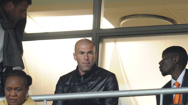 France legend Zinedine Zidane looks on.