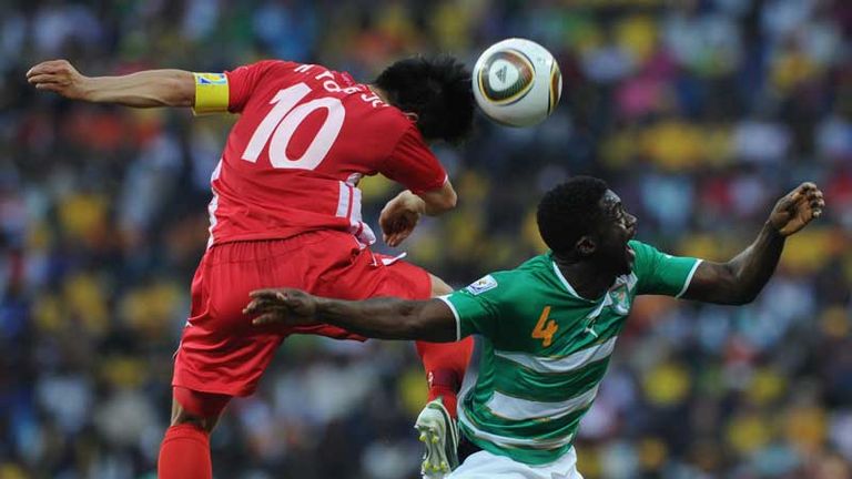 Kolo Toure is challenged by Hong Yong-Jo