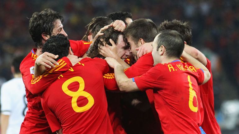 The Spain players embrace their hero after booking their spot in the final