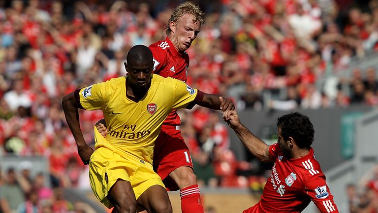 Abou Diaby is tackled by Dirk Kuyt and Javier Mascherano.