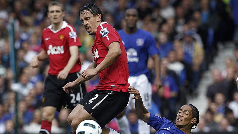 Steven Pienaar and Gary Neville tangle as the game gets under way at Goodison