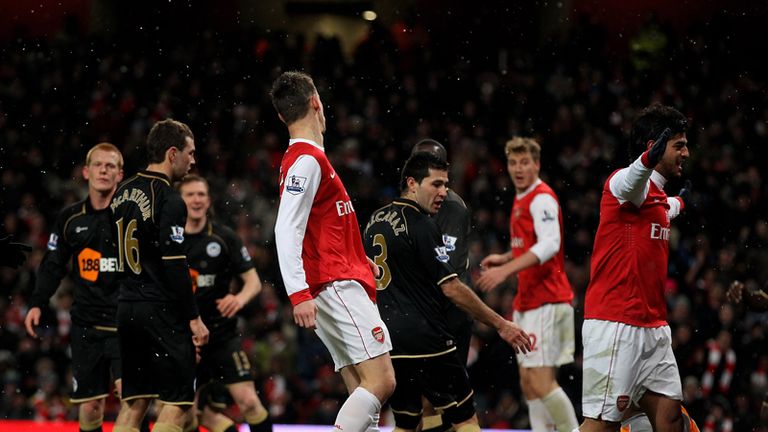 Carlos Vela of Arsenal celebrates as Wigans Antolin Alcaraz scores an own goal to give the Gunners a first-half lead