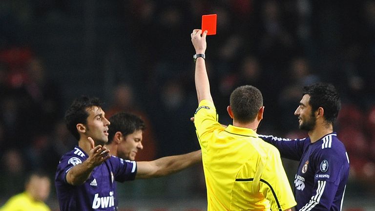 Referee Craig Thomson of Scotland sends off Xabi Alonso for time wasting as Real Madrid eventually finish with just nine men at Ajax.
