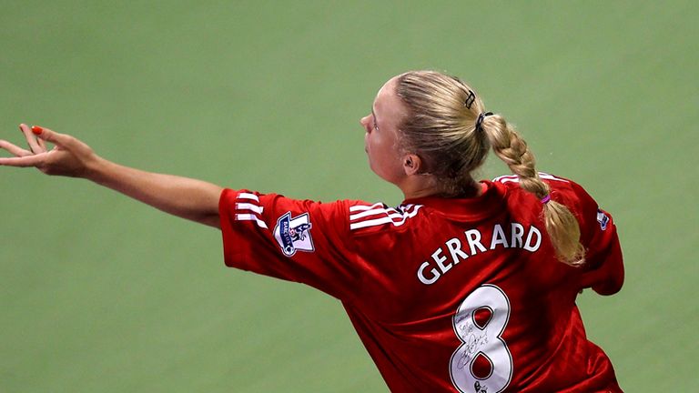 wearing Liverpool shirt at Doha