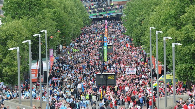 Fans make their way down Wembley Way towards the stadium before kick off