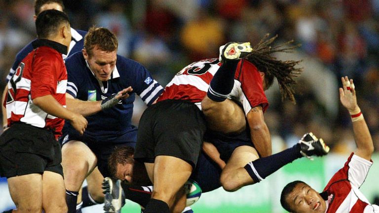 Scottish centre Andy Craig is picked up and dumped by Japan's Ruben Parker