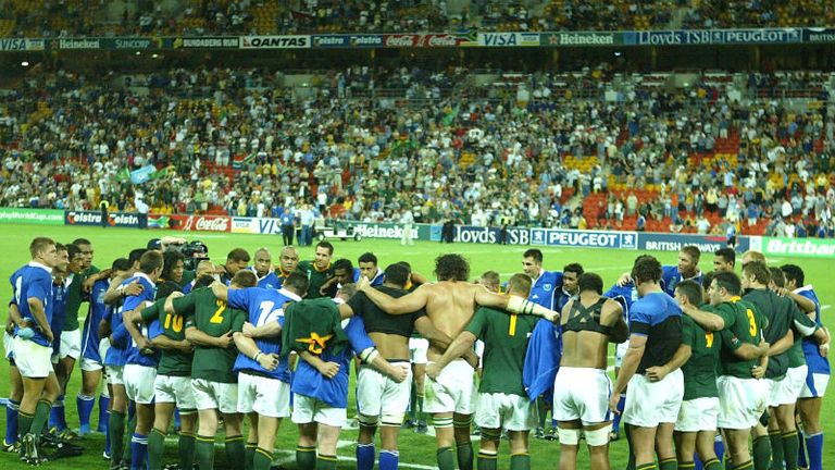 The South African and Samoan teams gather together for prayer following the final whistle