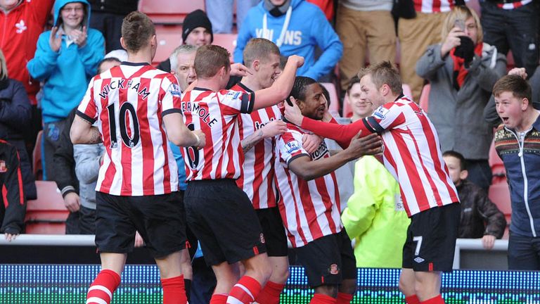 Celebration time: Sunderland's players mob Sessegnon after he scored