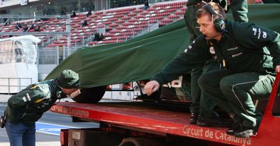 Vitaly Petrov inspects the stricken CT01