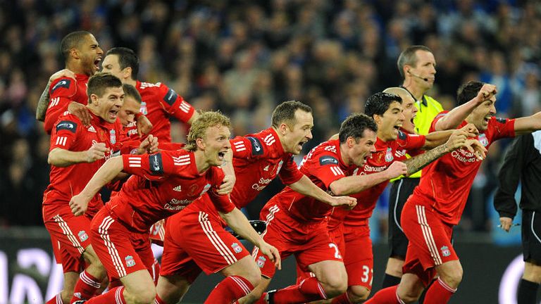 Liverpool players rush to celebrate their victory in the penalty shoot-out