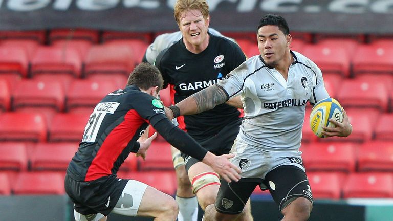 Manu Tuilagi (R): The powerful centre sets off on a barnstorming run against Saracens