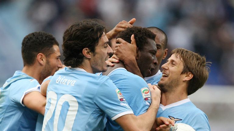 Mobido Diakite is mobbed by team-mates after scoring Lazios late winner against Cagliari