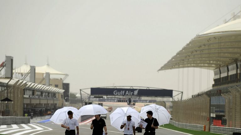 Narain Karthikeyan takes shade from the sun during his track walk