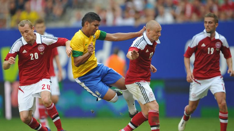 Casimiro of Brazil is challenged by Thomas Kahlenberg and Niki Zimling of Denmark in May 2012 