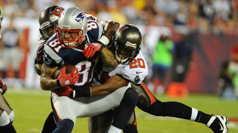 Hernandez is being tackled by Ronde Barber