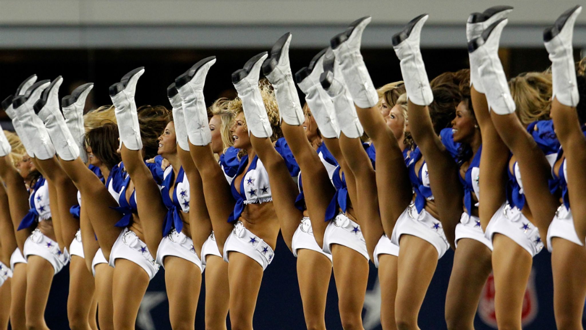 This Dallas Cowboys Cheerleader, Angela (the team does not publicize the  last names of its cheerleading squad members), and about 35 others,  entertain the crowd at a National Football League game at