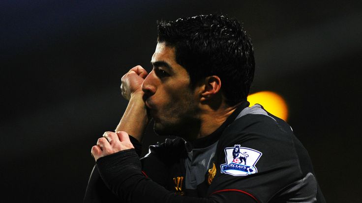 Luis Suarez celebrates after scoring twice for Liverpool in the opening 16 minutes at QPR