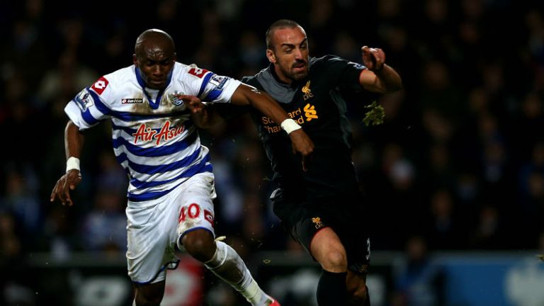 Jose Enrique of Liverpool is challenged by QPRs Stephane Mbia
