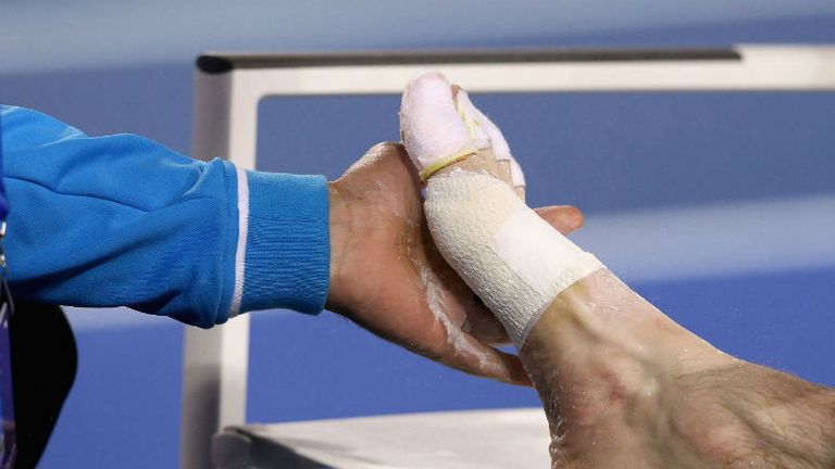 Andy Murray receives medical attention to his foot after losing the second set of the Australian Open mens final