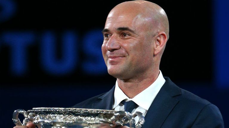 Four-time Australian Open mens singles champion Andre Agassi carries the Norman Brookes Challenge Cup ahead of the mens final