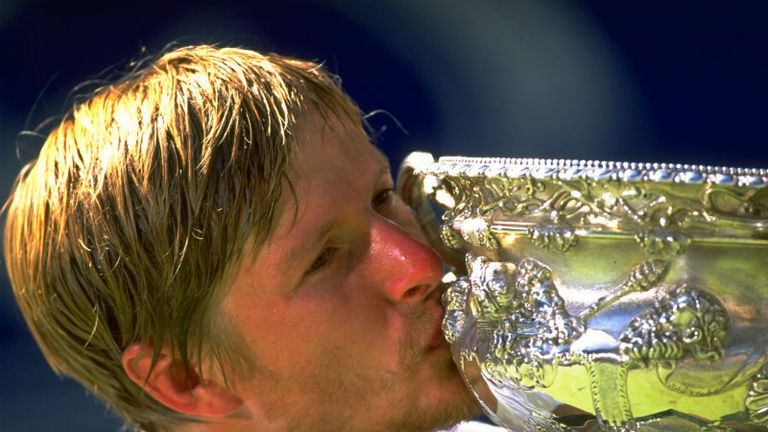 Yevgeny Kafelnikov of Russia kisses the trophy after winning the Australian Open in 1999