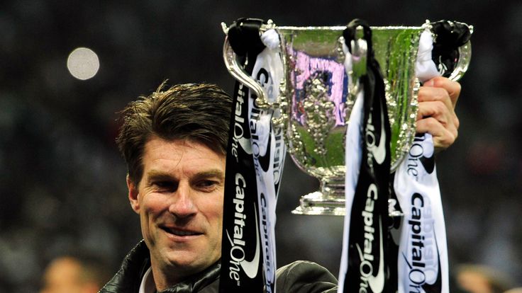 Swansea City manager Michael Laudrup celebrates with the trophy after the League Cup final