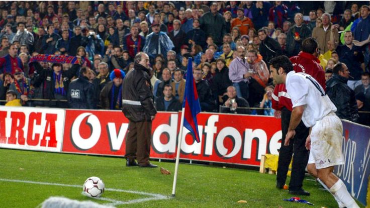 Luis Figo is bombarded with missiles as he takes a corner in the Camp Nou