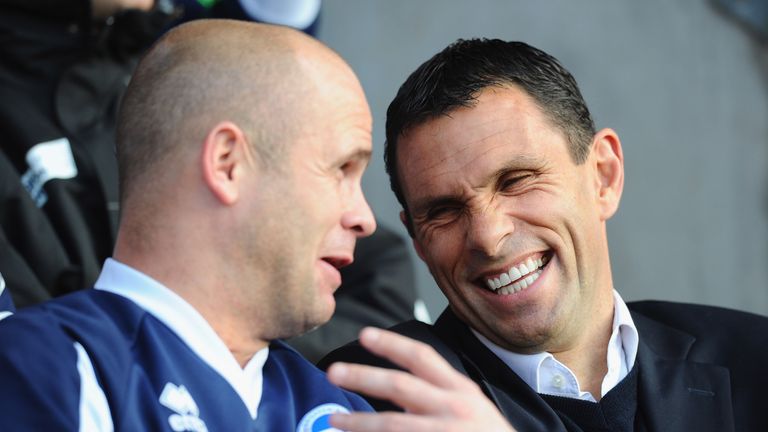 Brighton manager Gus Poyet shares a joke with assistant coach Charlie Oatway