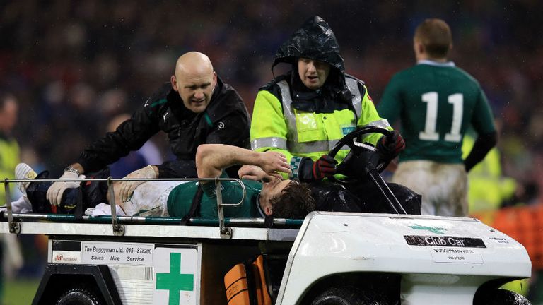 Eoin Reddan of Ireland is stretchered off