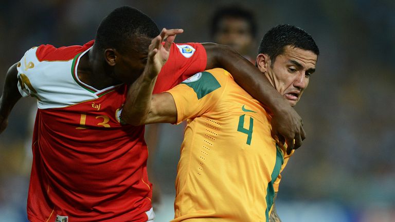 Australia's Tim Cahill is tackled by Abdul Sallam al Mukhaini from Oman 