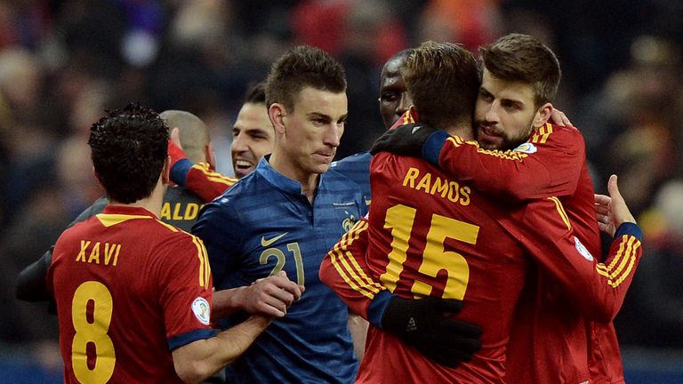 Xavi Hernandez, Sergio Ramos and Gerard Pique celebrate next to France's defender Laurent Koscielny after Spain's 1-0 win over France.
