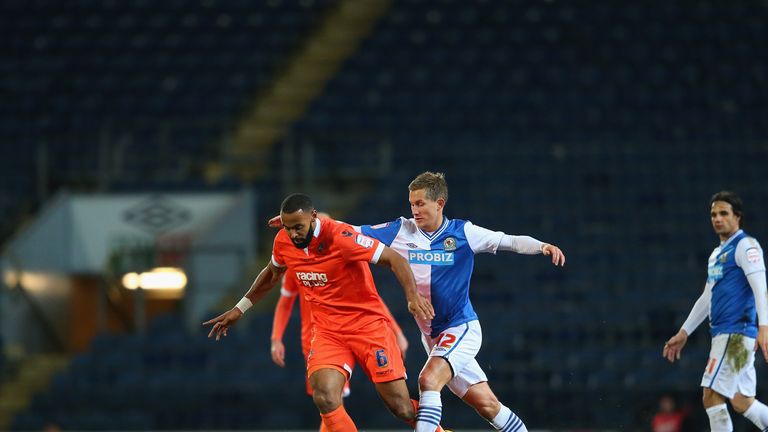 Liam Trotter of Millwall competes with Morten Gamst Pedersen of Blackburn Rovers during the FA Cup Sixth Round Replay.