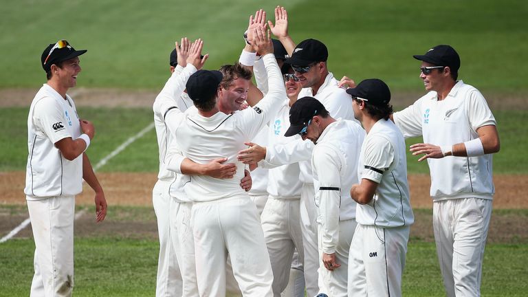 New Zealand celebrate with Bruce Martin during the second day of the first Test against England at the University Oval