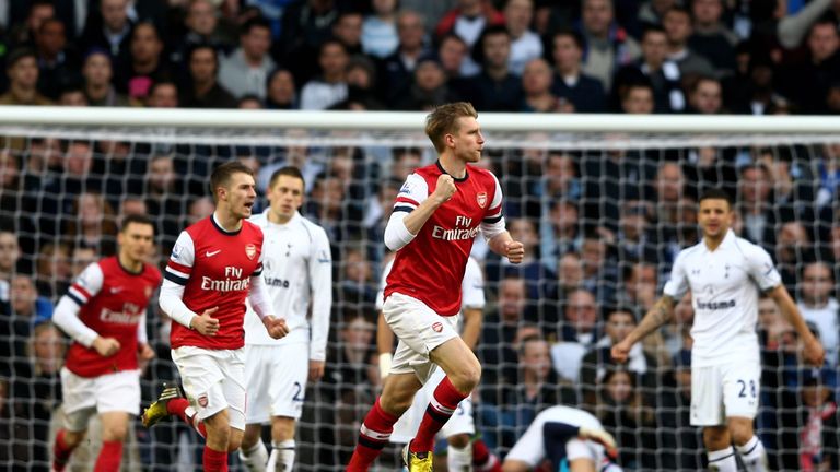 Per Mertesacker of Arsenal celebrates after scoring his team's first goal during the Premier League match between Tottenham Hotspur and Arsenal