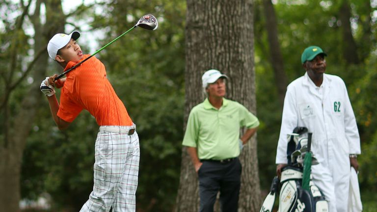 Ben Crenshaw looks on as Guan Tianlang drives off