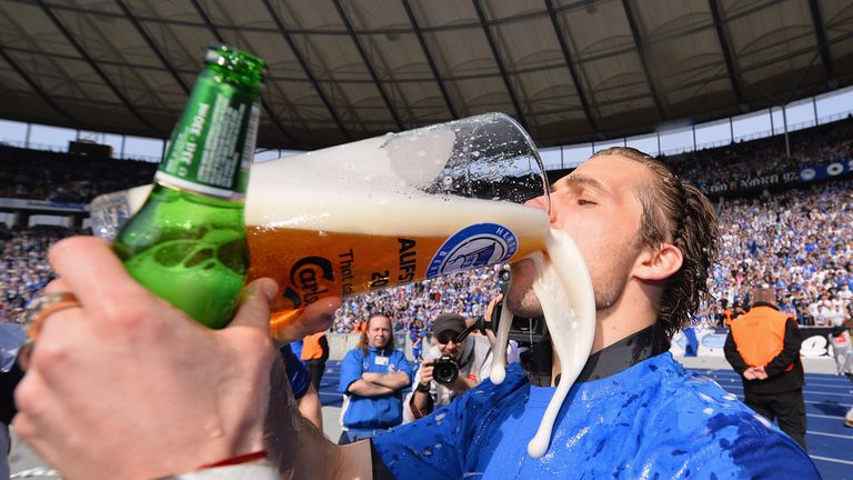 Peter Pekarik of Hertha Berlin celebrates with a beer as team-mates celebrate their teams promotion to the first league at the end of the second Bundesliga match between Hertha Berlin SC and SV Sandhausen at Olympiastadion on April 21, 2013 in Berlin, Germany.