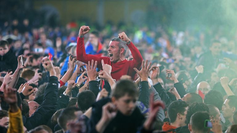 Kevin McNaughton celebrates with fans of Cardiff City after promotion to the Premier League.