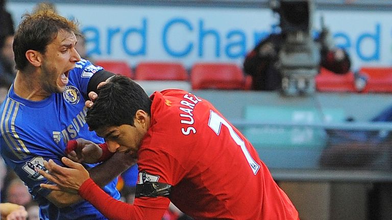 Liverpool's Uruguayan striker Luis Suarez (R) clashes with Chelsea's Serbian defender Branislav Ivanovic (L) after appearing to bite the Chelsea player during the English Premier League football match between Liverpool and Chelsea at the Anfield